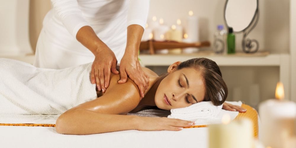 Woman receiving a massage at a day spa.