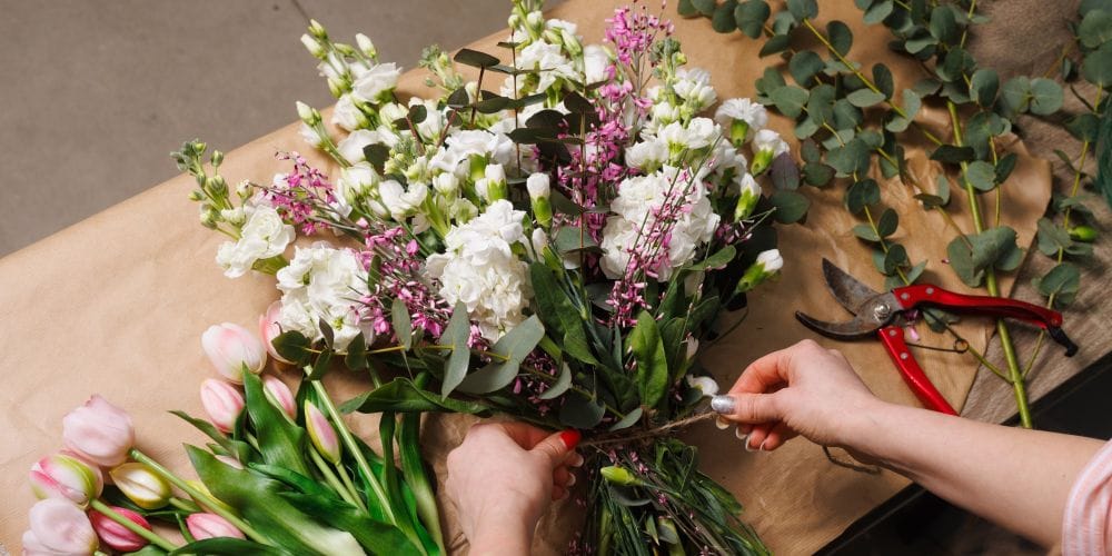 Florist creating a bouquet of flowers.