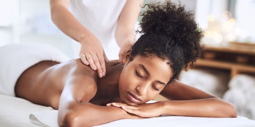 Woman receiving a neck massage at a massage studio.